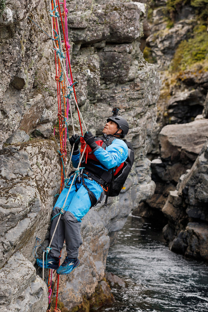 Emilio Navarro climbing the side of a cliff in Race to Survive: New Zealand