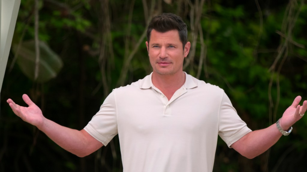 Nick Lachey in a white shirt holding his hands up on Season 2 of Perfect Match