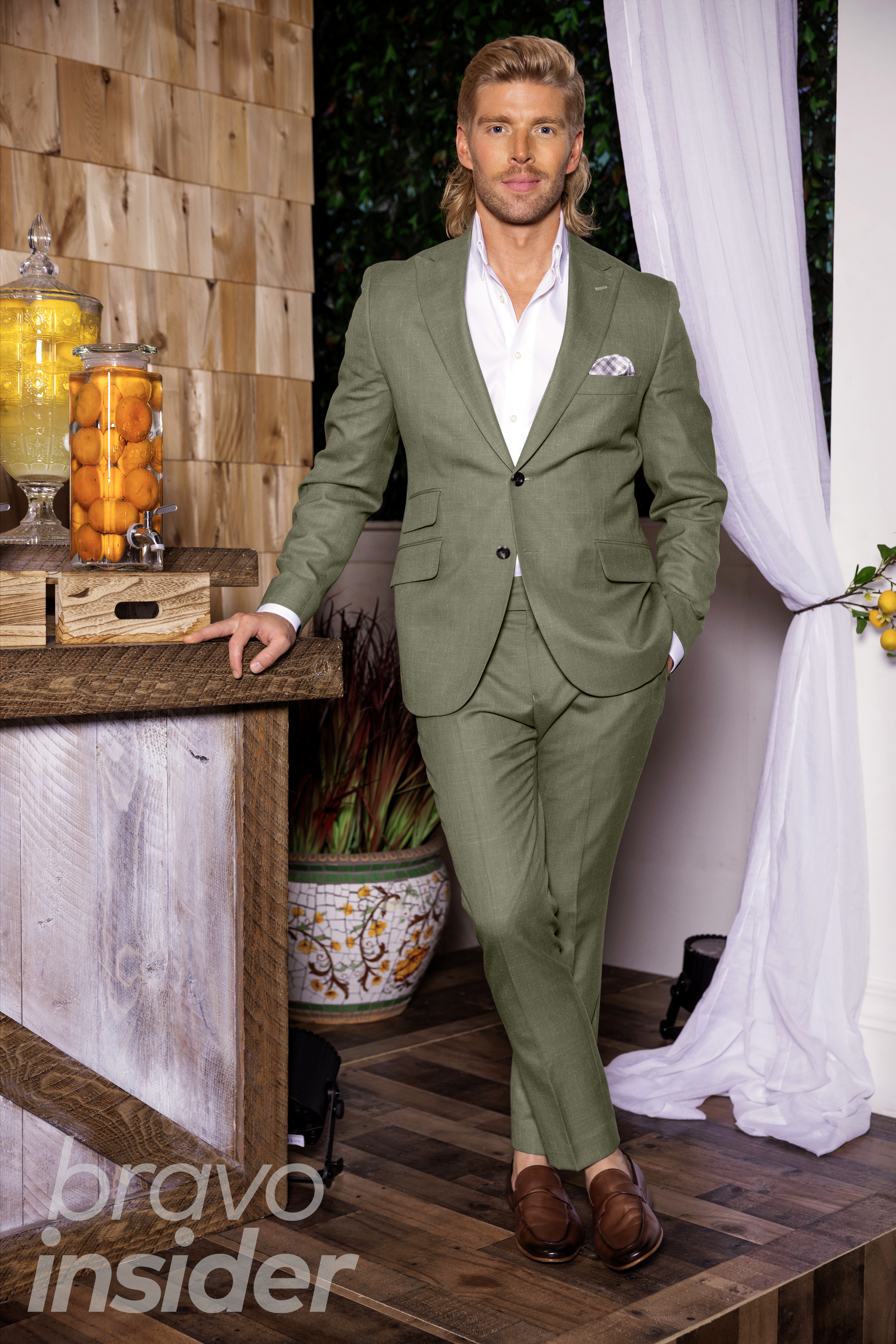 Kyle Cooke posing at the Summer House Season 8 reunion in a green suit