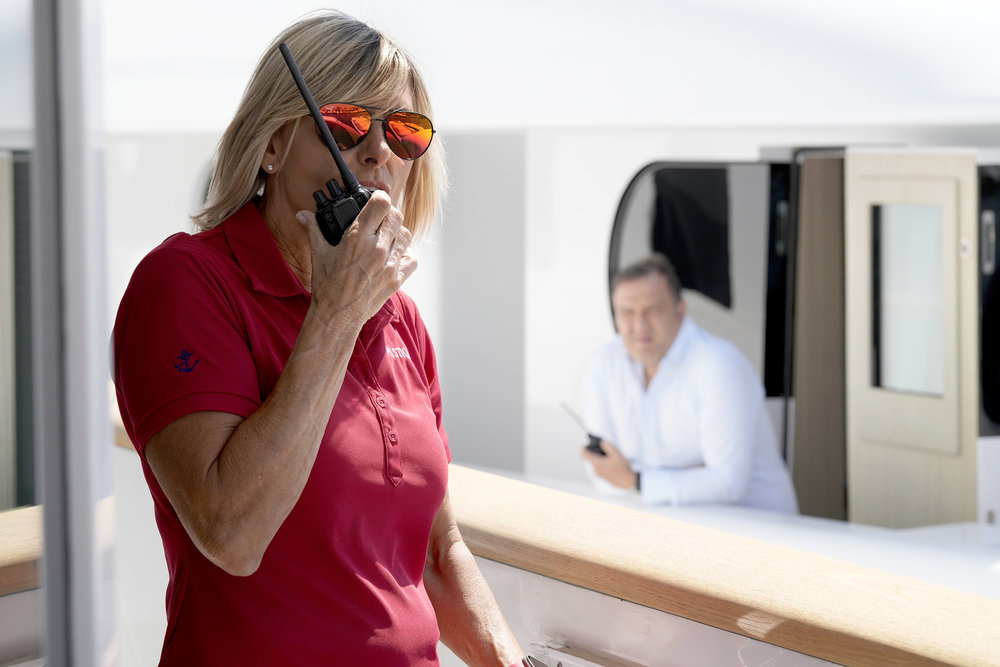 Captain Sandy on Below Deck Med talking into a walkie talkie