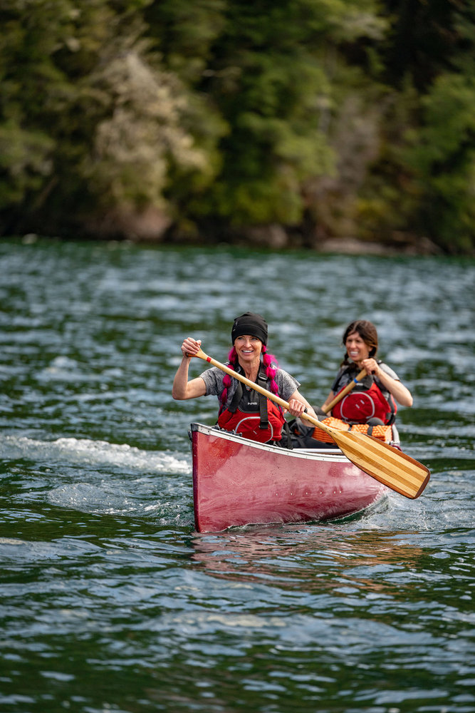 Ashley and Rhandi riding in a canoe on Race to Survive: New Zealand