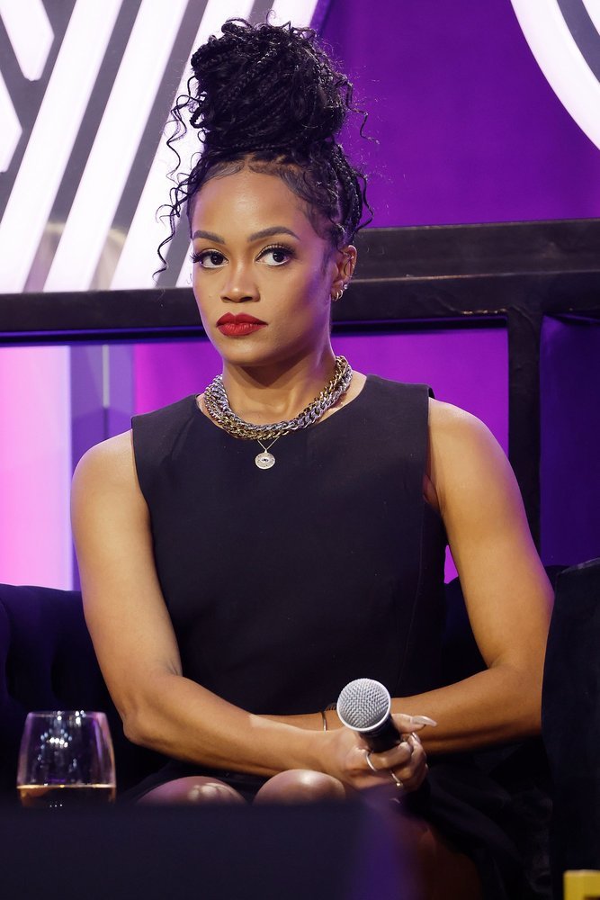 Rachel Lindsay at BravoCon 2023 making a side eye and holding a microphone