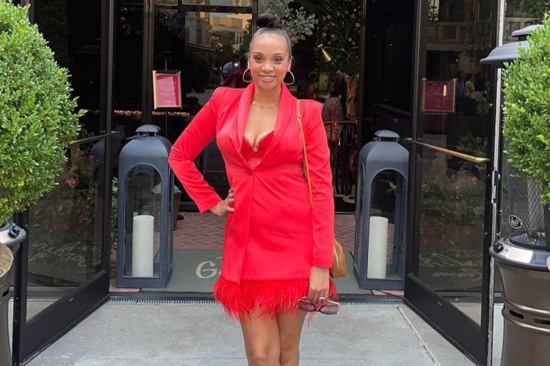 Dr. Mirica Sanders posing in a red dress with her hand on her hip