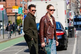 Gigi Hadid and Bradley Cooper walking through traffic in New York City