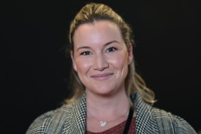 Hannah Ferrier smiling and wearing a grey jacket