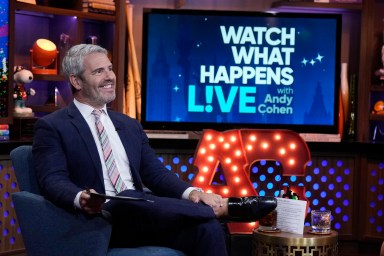 Andy Cohen smiling in his seat on Watch What Happens Live