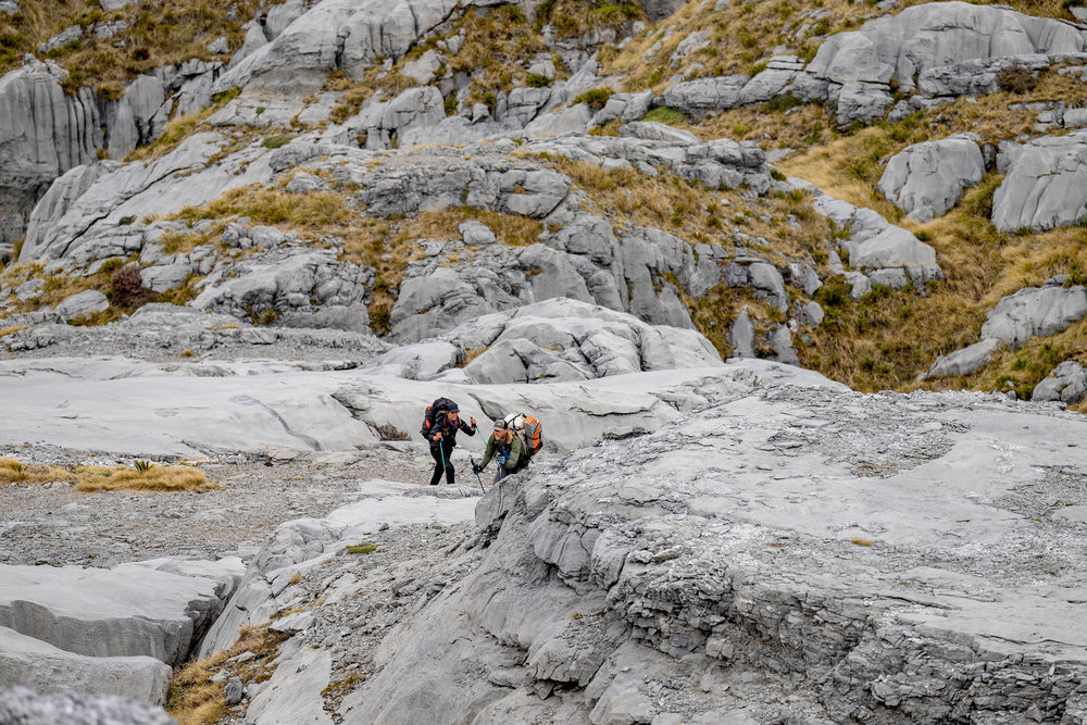 Paulina and Creighton going across rocks on Race to Survive: New Zealand