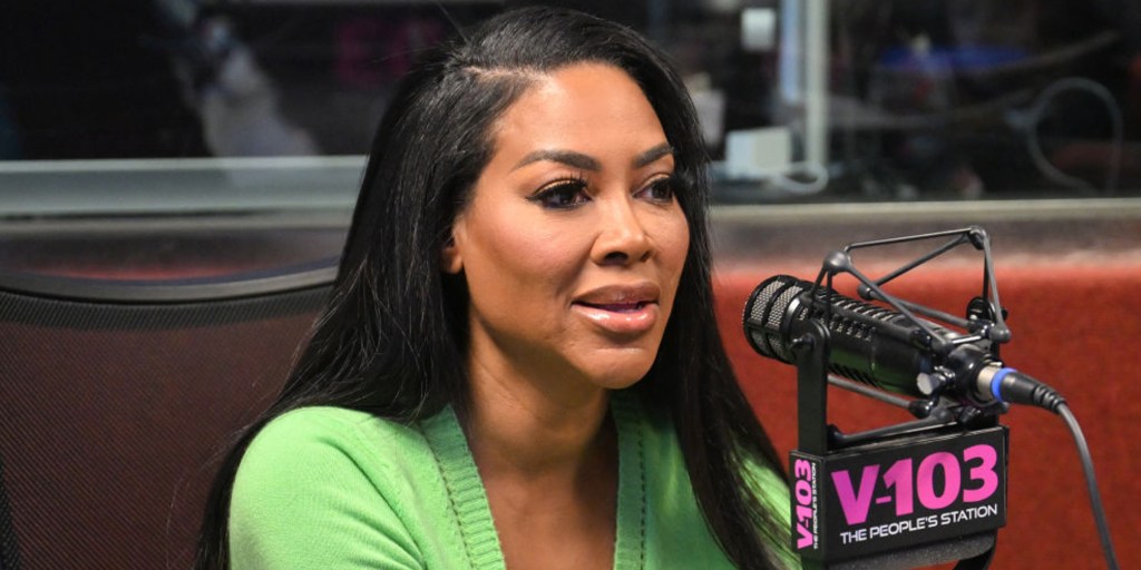 Real Housewives of Atlanta alum Kenya Moore giving a radio interview.