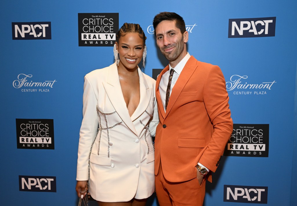 Catfish hosts Nev Schulman and Kamie Crawford posing together at a red carpet