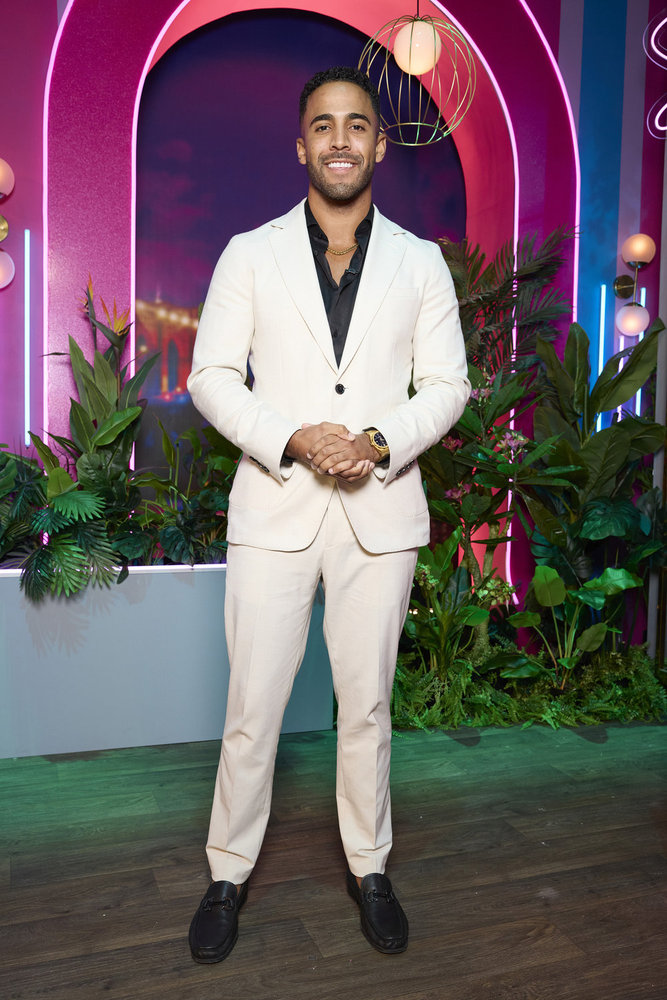 Kendall Washington poses in a white suit at the Love Island USA season 6 reunion 