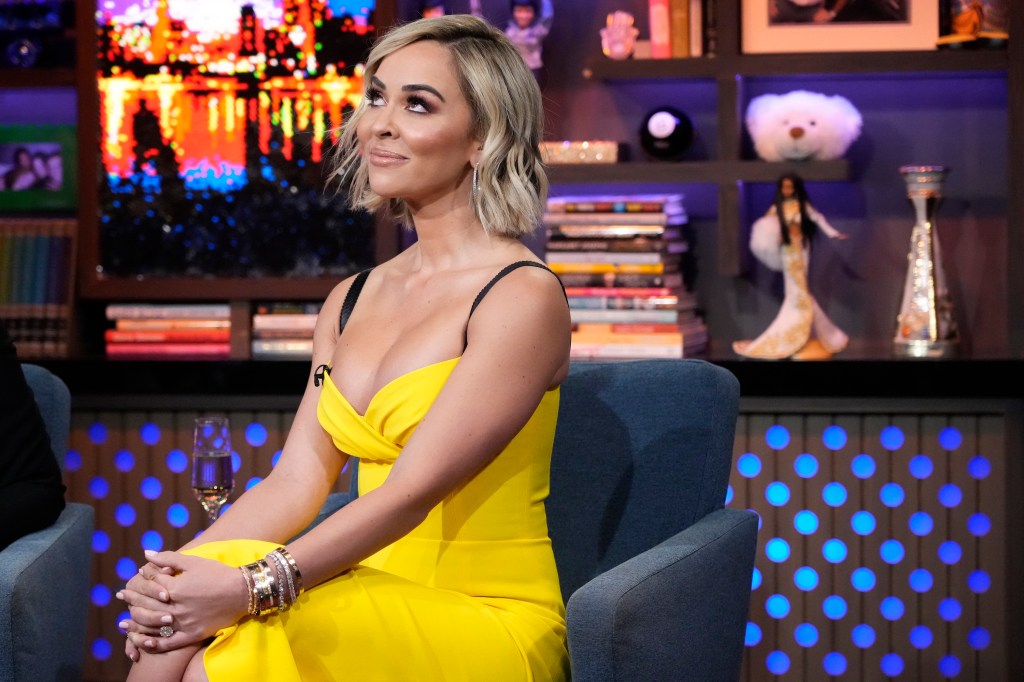 RHOM's Dr. Nicole Martin in a yellow dress looking up on WWHL.