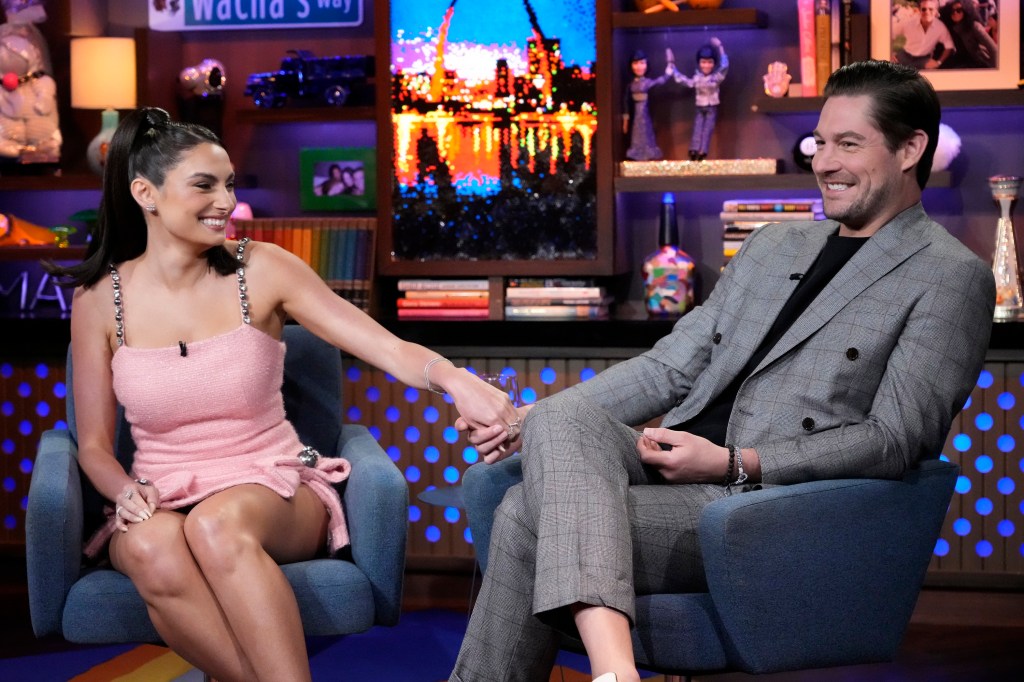 Paige DeSorbo and Craig Conover holding hands on WWHL.