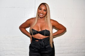 NeNe Leakes smiling with her hands on her hips