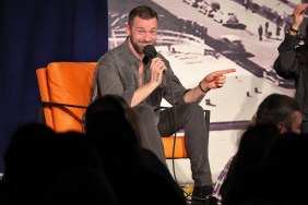 Artem Chigvintsev on a stage holding a microphone.