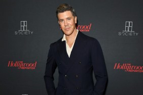 Fredrik Eklund in a black suit posing in front of a black backdrop