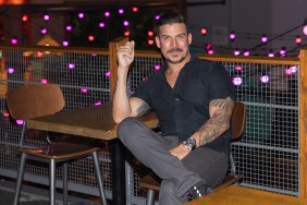 Jax Taylor sitting at a table with his legs crossed