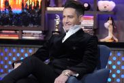 Josh Flagg wearing a suit with a high collar on WWHL.