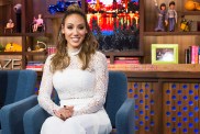 Melissa Gorga in a white outfit and smiling on WWHL.