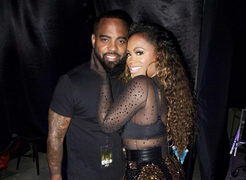 Husband and wife, Todd Tucker and Kandi Burruss posing backstage. 