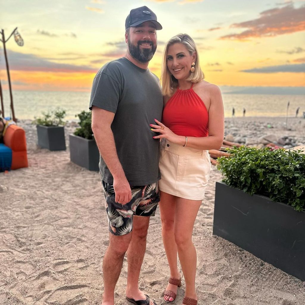 Travis Mullen and Gina Kirschenheiter posing on a beach