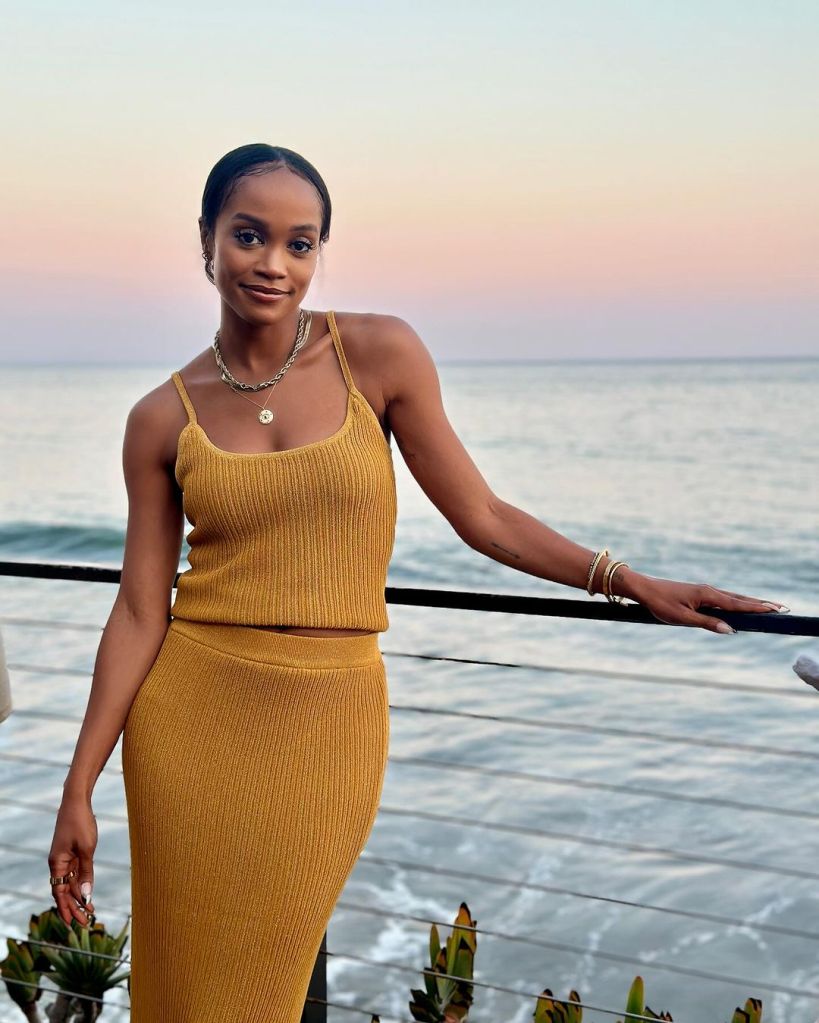 Rachel Lindsay posing on a balcony in a yellow dress