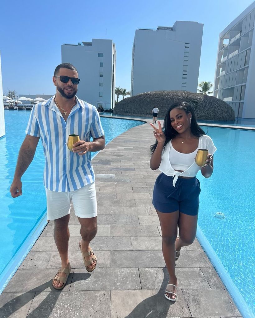 Tyler Francis and Ashley Adionser walking alongside a pool