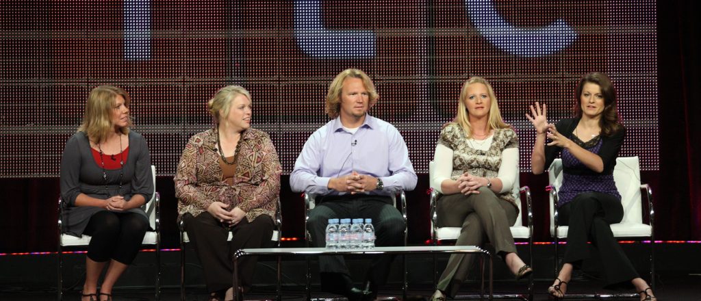 Cast of Sister Wives sitting on a panel.