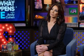 Danielle Staub in a navy blue polka dot dress sitting on Watch What Happens Live