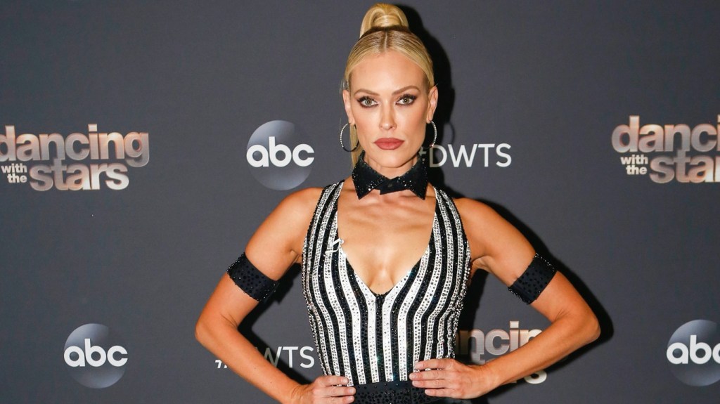 Peta Murgatroyd in a black and white shirt posing with her hands on her hips