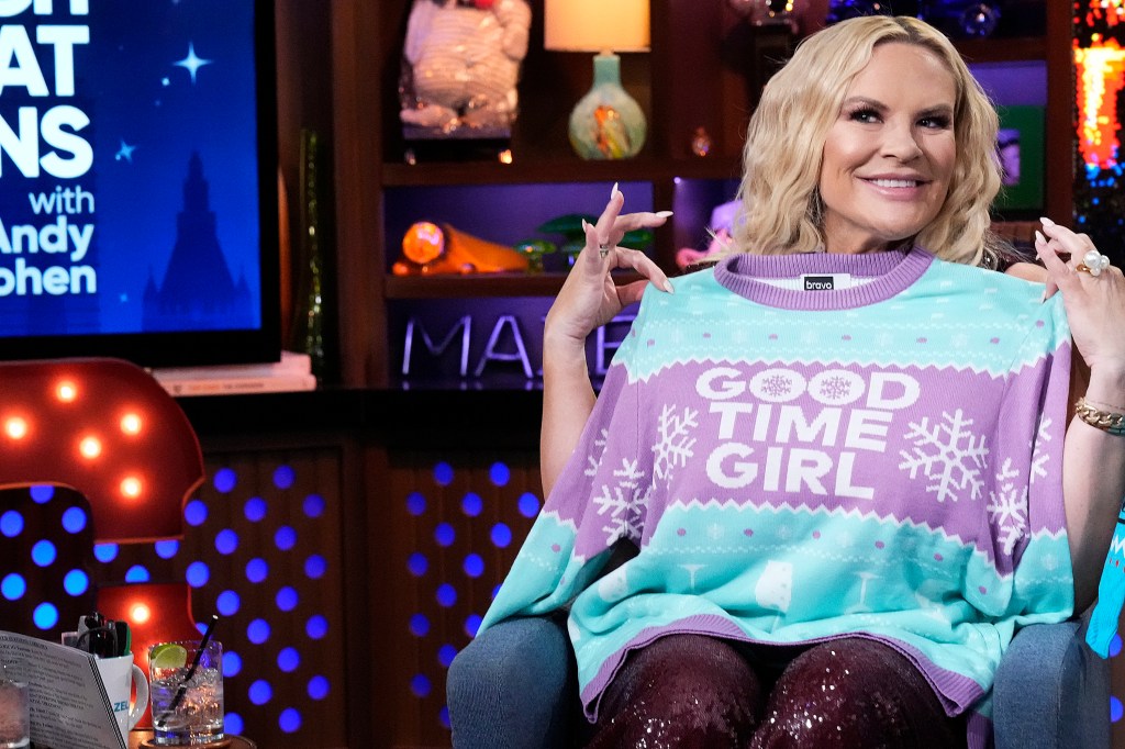 Heather Gay holding up a shirt that says "Good Time Girl" on Watch What Happens Live