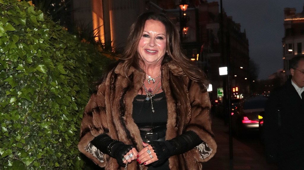 Fran Cutler walking in a fur coat