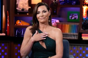 Countess Luann de Lesseps in a black dress holding her hand over her heart on Watch What Happens Live