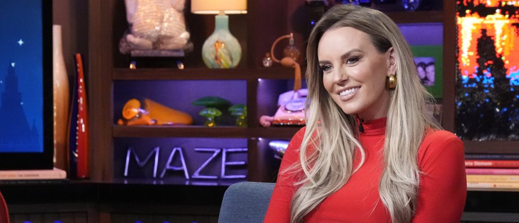 RHOSLC star Whitney Rose in a red dress and smiling on WWHL.