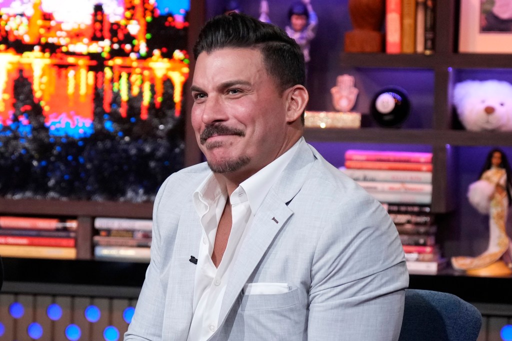 Jax Taylor looking bewildered in a light-colored suit on WWHL.