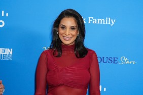 RHONY star Jessel Taank in a red outfit against a blue background.