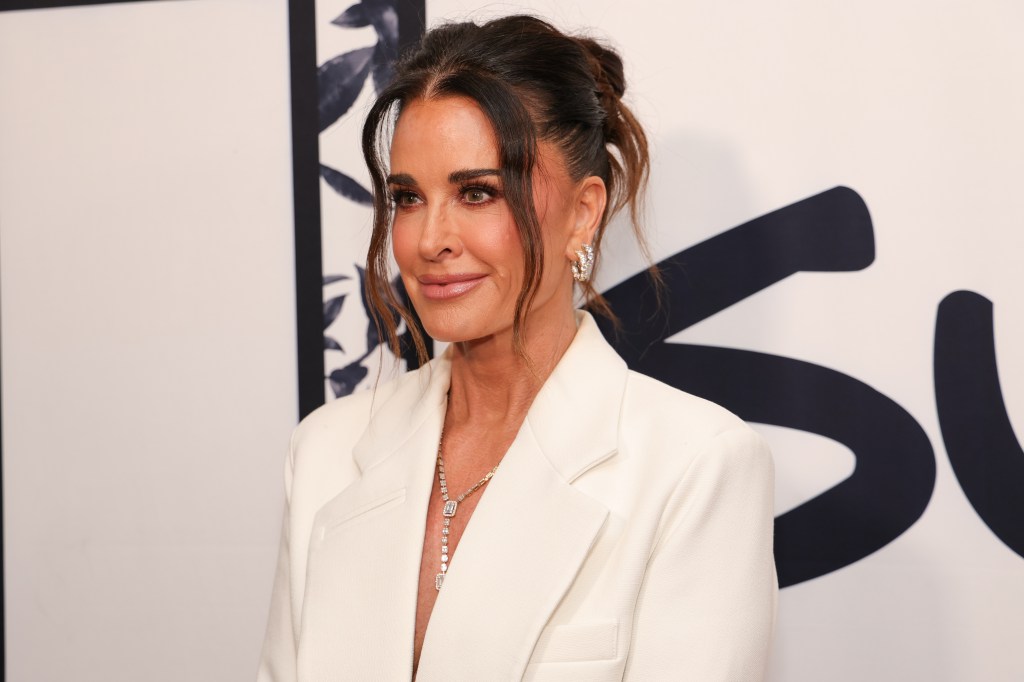 RHOBH OG Kyle Richards in a white suit with her hair in an updo.