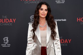 Kyle Richards in a white satin blazer at an event.