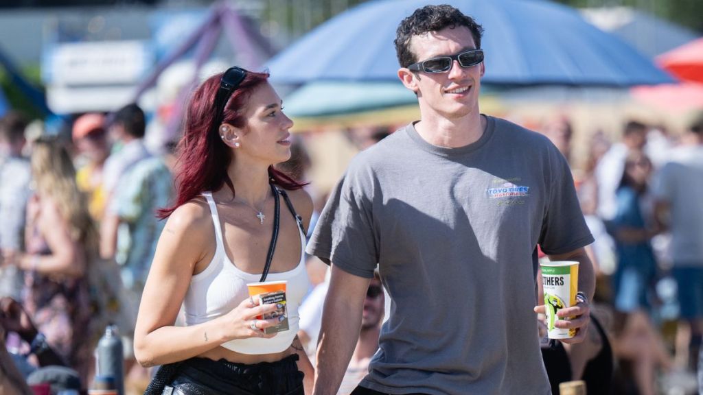 Dua Lipa and Callum Turner during day four of Glastonbury Festival 2024 at Worthy Farm, Pilton on June 29, 2024 in Glastonbury, England. Founded by Michael Eavis in 1970, Glastonbury Festival features around 3,000 performances across over 80 stages. Renowned for its vibrant atmosphere and iconic Pyramid Stage, the festival offers a diverse lineup of music and arts, embodying a spirit of community, creativity, and environmental consciousness.