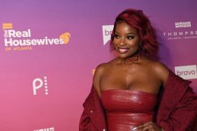 Shamea Morton at a RHOA premiere event wearing a red dress and red hair